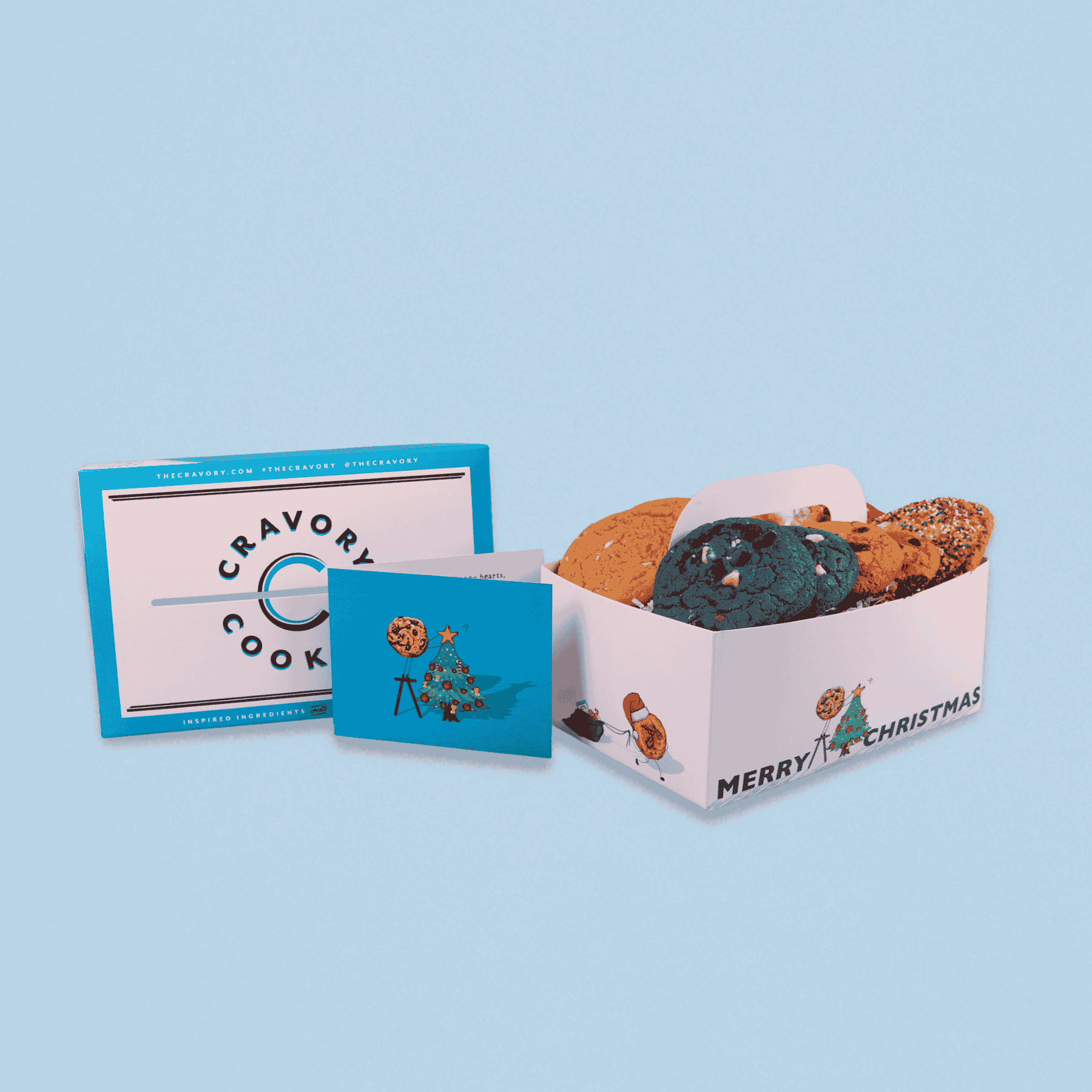 Box of cookies with a card on a light blue background